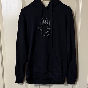 Elegant Black Hoodie with Abstract Face Design